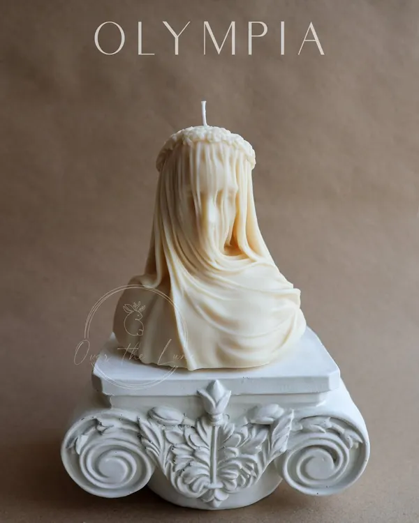 This is my exquisite Veiled Lady bust candle, the star of the Olympia collection. Handcrafted from natural soy wax, its intricate details and French Vanilla scent make it a sophisticated work of art for your home.