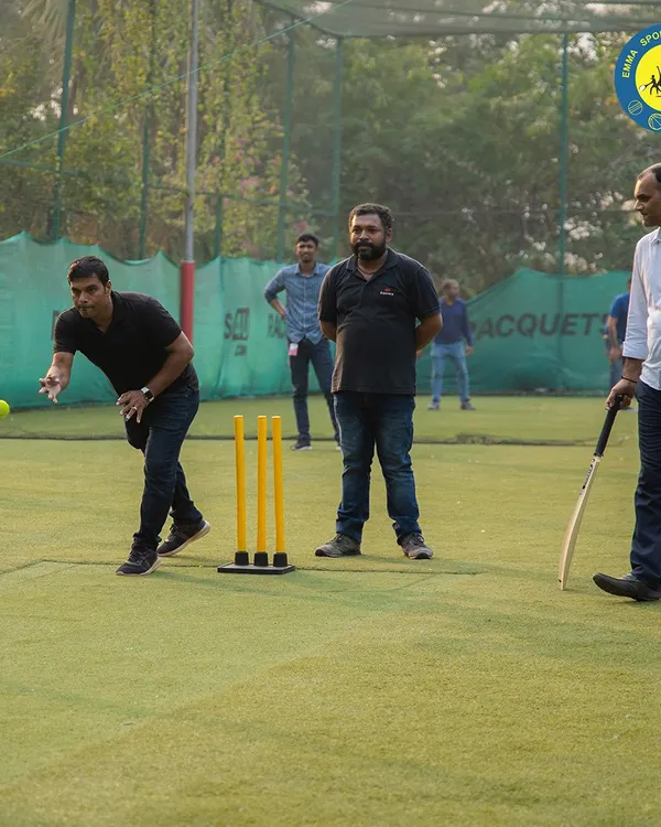 A player delivers a fast bowl during a competitive game of box cricket. Our turf is the perfect arena for bowlers and batsmen to test their skills against each other.
