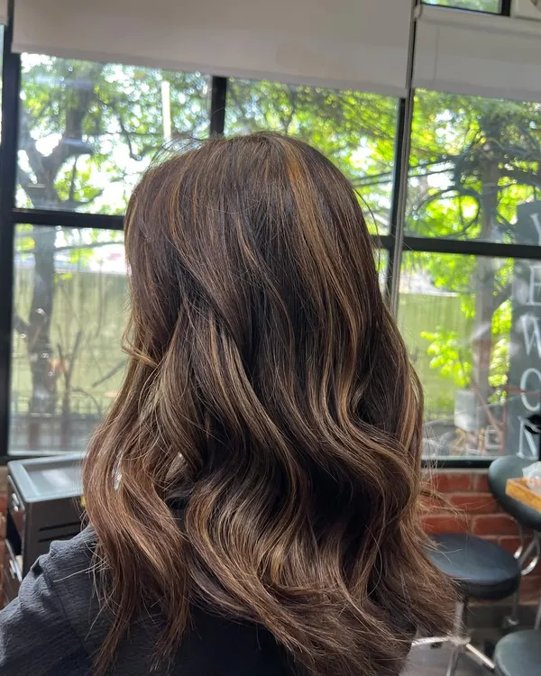 This is an example of a soft balayage I did. The hand painted highlights create a natural, sun kissed effect with beautiful dimension and soft waves.