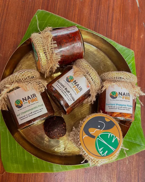 This is the heart of my kitchen, bottled for yours. My signature Suriani Buff and Prawn Pickles, alongside the essential Chammanthi Podi, are all handmade in small batches. Presented on a traditional brass thali, this is a glimpse into the authentic, unapologetic flavours of my family's Tharavadu recipes.