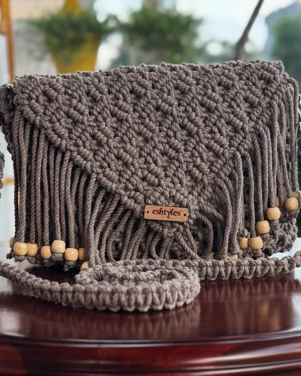 This is one of my absolute favorite designs. A beautiful boho-style sling bag with intricate knots and wooden beads, perfect for adding a touch of handcrafted charm to any outfit.