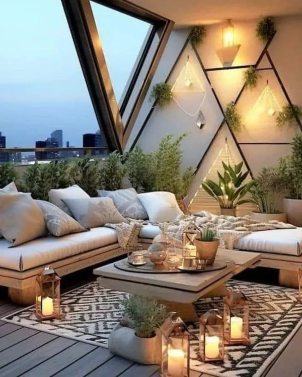 A bohemian-inspired balcony design featuring low wooden seating, layered rugs, and an abundance of plants and lanterns. This setup creates a cozy and inviting space perfect for relaxing evenings.