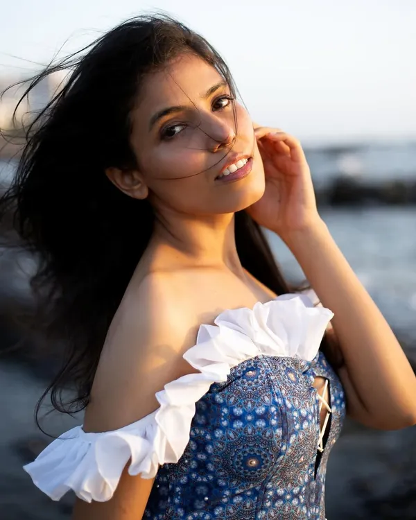 A classic golden hour portrait. The warm light and gentle breeze create a soft, romantic mood, perfect for capturing natural beauty.