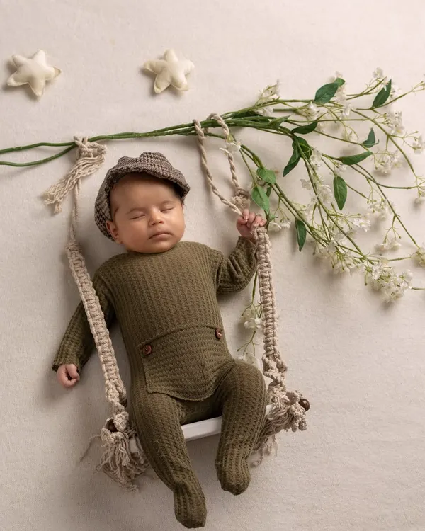 A dapper little gentleman. This peaceful, posed shot on a swing is a beautiful example of the artistic and creative portraits I love to create for newborns.