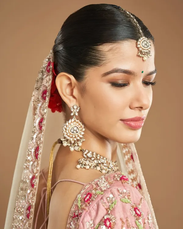 This is the essence of the modern Indian bride. I focused on creating that signature 'Nam Glow' with dewy, luminous skin, paired with a soft brown smokey eye and a gentle pink lip to complement the beautiful pastel lehenga.