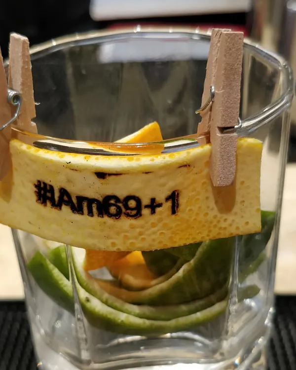 A perfect example of our personalized service. For this 70th birthday, we created custom orange peel garnishes heat-stamped with the event's hashtag, "#IAm69+1," adding a witty and memorable touch to each drink.