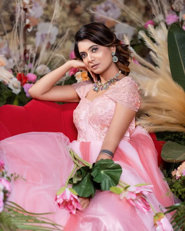 A dreamy shot of the pink princess ball gown, featuring a textured bodice and a multi-layered tulle skirt.