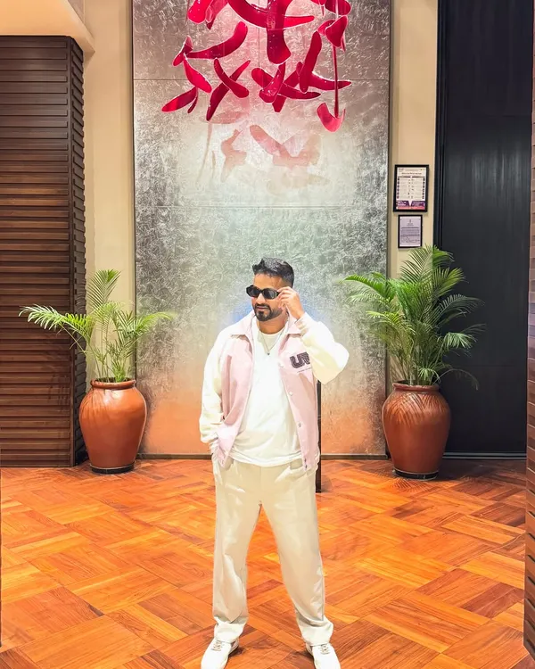 A stylish pose against a backdrop of modern art.