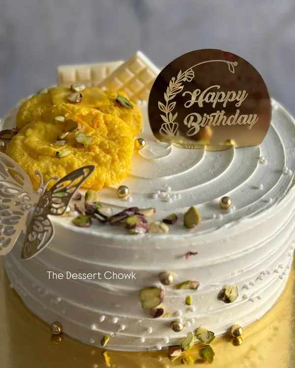 My signature Royal Rasmalai cake. This eggless cake is infused with the delicate flavours of rasmalai and garnished with pistachios and a piece of the sweet itself.