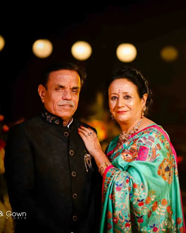 A beautiful, classic portrait of the groom's parents. Their proud and happy expressions are a wonderful part of the wedding story.
