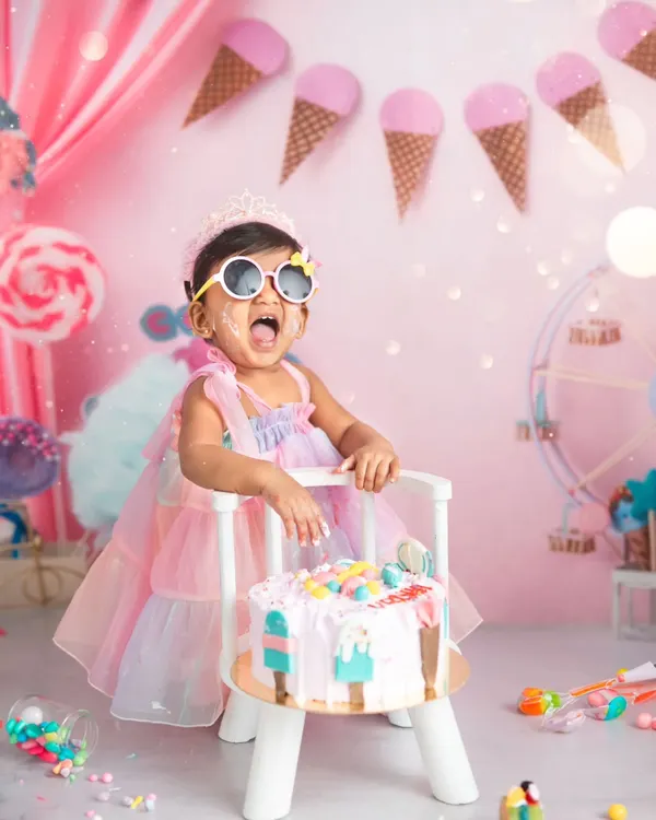 A joyful first birthday celebration featuring our popular ice cream parlor theme. This cake smash session captures the pure, messy fun of turning one, complete with a custom cake, colorful props, and a very happy toddler.