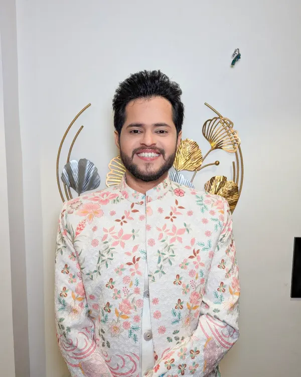 A groom in a beautiful floral sherwani. This is a fresh and modern take on traditional wedding wear, perfect for a day event.