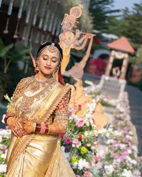 A bride embodying pure radiance in a custom golden Kanjivaram silk saree. This is what I mean by creating a legacy; an outfit designed to be timeless, capturing the grandeur of her wedding day.