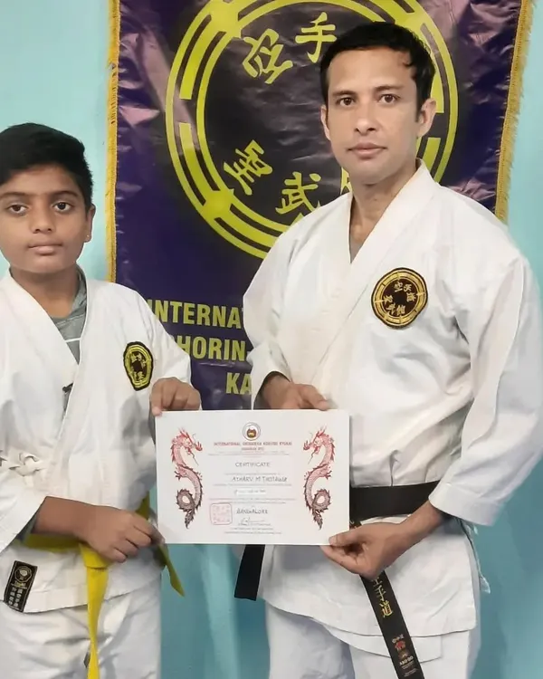 A student proudly holds his certificate after a successful grading examination. These events are an important part of our training, marking milestones in a student's journey and reinforcing the value of perseverance.