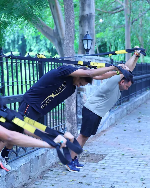 Using TRX suspension trainers to build upper body and core strength. We use the park's environment to our advantage, setting up our gear anywhere for a challenging workout.