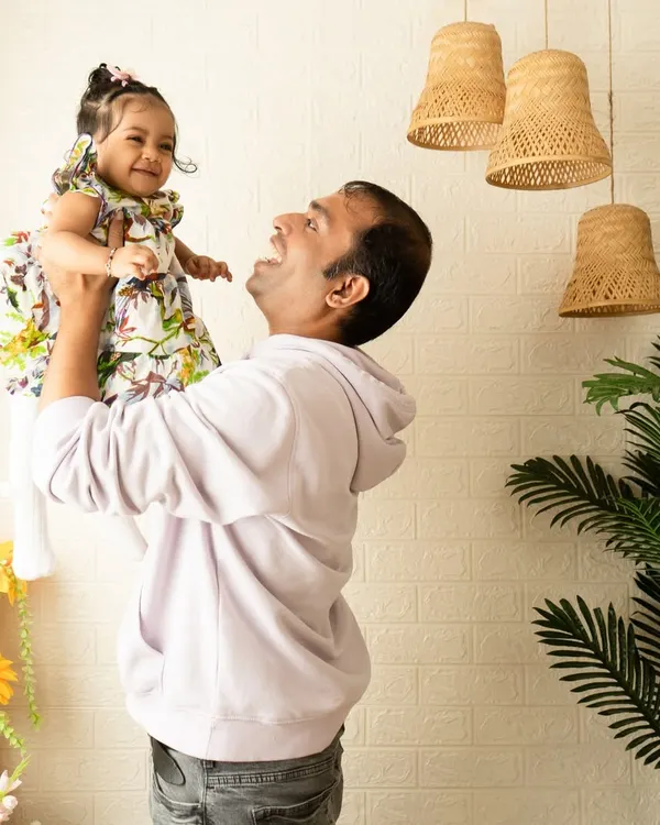 A candid, joyful moment between a father and his daughter. These unposed shots are often the most powerful, capturing the pure love and connection within a family.