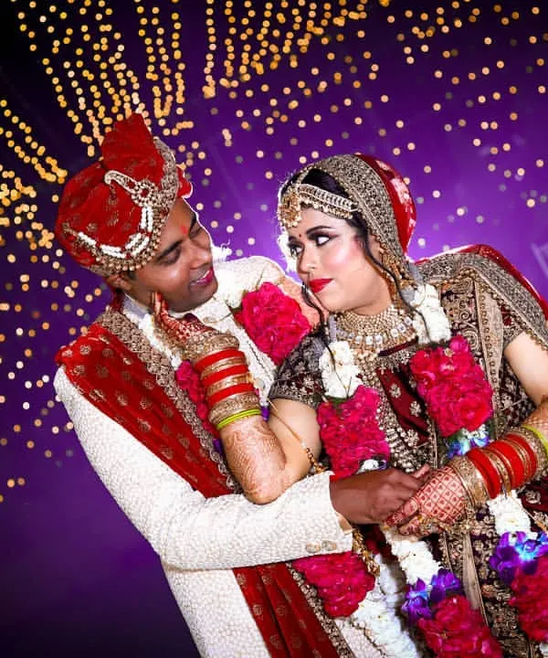 A romantic couple portrait against a backdrop of sparkling fairy lights. We use creative lighting to create a magical and dreamy atmosphere for your wedding photos.
