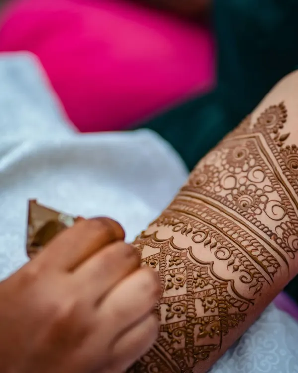 A close-up shot of the henna cone in action. I take great care to ensure every line is crisp and every detail is perfect, building the design layer by layer.