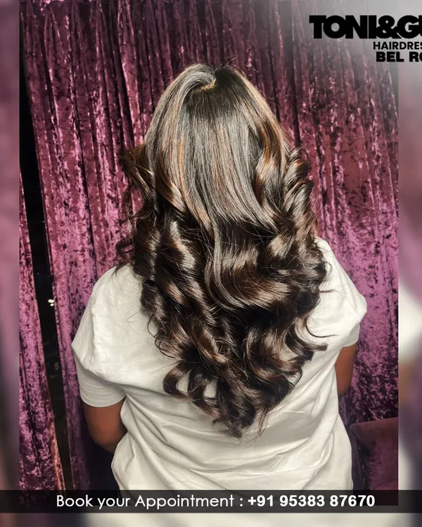 This is how we bring glamour to long hair. We created deep, uniform curls to give this client's hair incredible volume, shine, and a perfect special-occasion style.