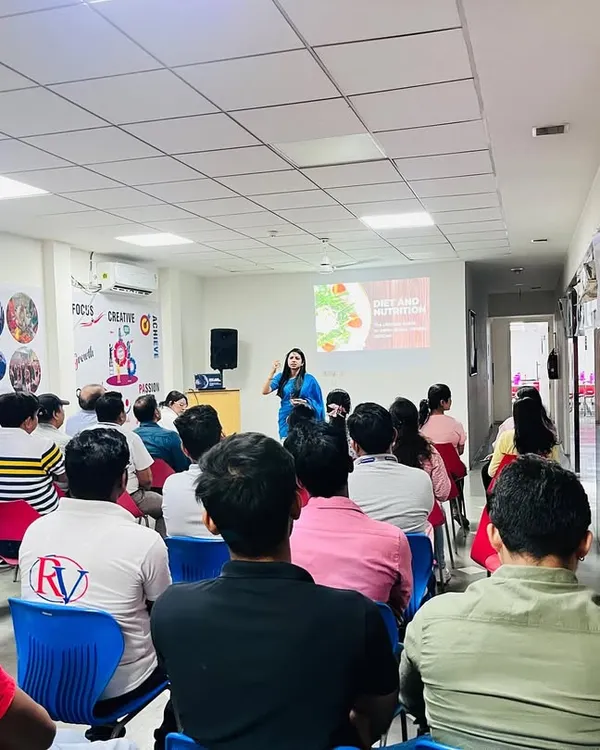 I believe learning about nutrition should be an active discussion, not a boring lecture. Here I am, conducting an interactive wellness workshop for the team at RV Solutions, focusing on practical diet changes for a high-energy workday.