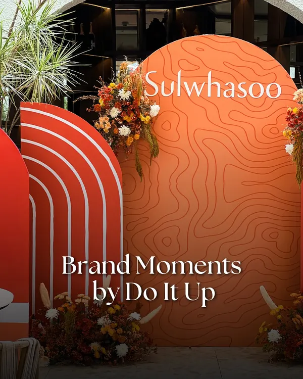 A custom backdrop for the Sulwhasoo launch, featuring their signature orange and topographic patterns to reflect the brand's connection to heritage and natural ingredients. This is a key element in our brand activation pop-up designs.