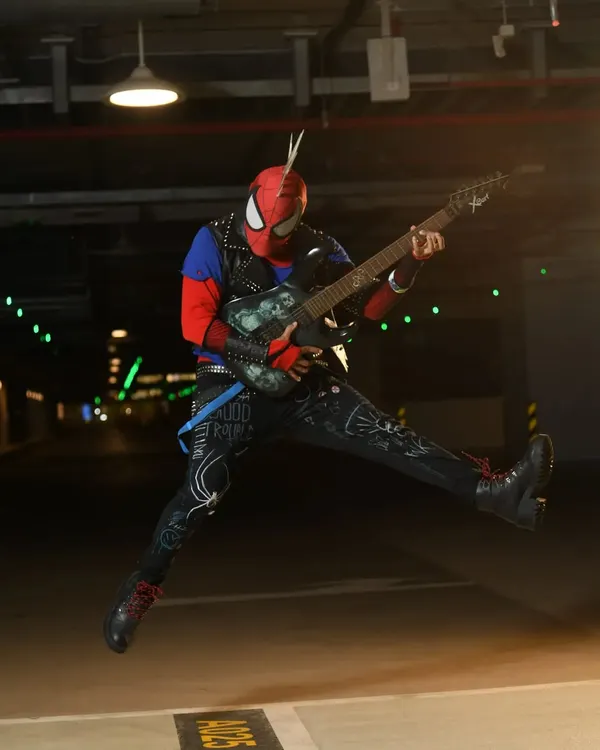 An action shot of my Spider-Punk cosplay. I made the entire suit, including hand-painting the details on the pants and weathering the jacket and guitar.