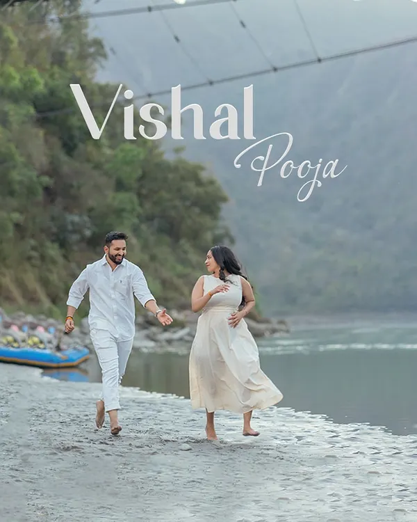 A playful chase along the sandy banks of the Ganga. This candid shot, with the suspension bridge in the background, perfectly captures the fun and carefree spirit of a Rishikesh pre-wedding shoot.