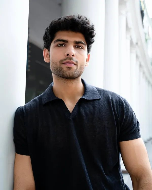 A strong headshot is essential for any model. This close-up, taken during an outdoor fashion shoot, captures a direct and confident gaze, showcasing the model's features with clean, natural lighting.