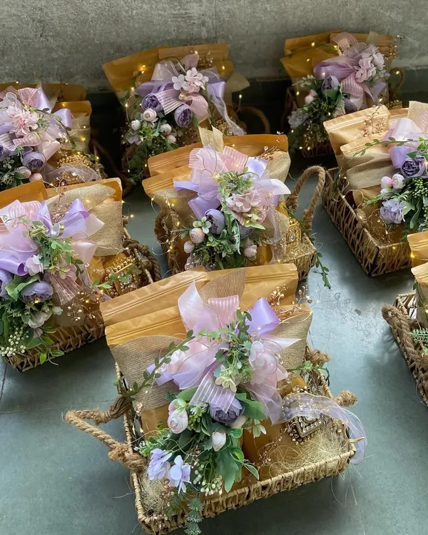A beautiful array of our custom hampers, each featuring a soft lavender floral theme and illuminated with delicate fairy lights. These are perfect for bulk orders for weddings or corporate events, ensuring every guest receives a memorable and elegant gift.