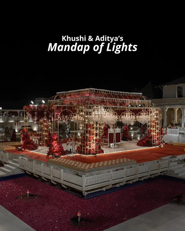 For Khushi and Aditya's 'Mandap of Lights', we designed a magnificent structure over a pool, using intricate gold framework, deep red florals, and hundreds of candles to create a warm, radiant glow against the night sky.
