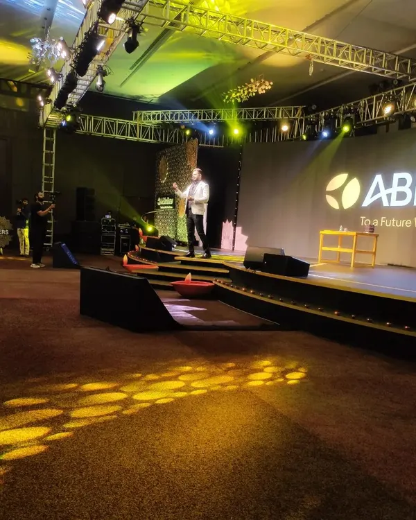 I command the stage at a large corporate event for ABInBev, held at the Hilton Bangalore. This wide-angle shot captures the scale and professional lighting of the productions I am a part of, setting the tone for a high-impact keynote experience.
