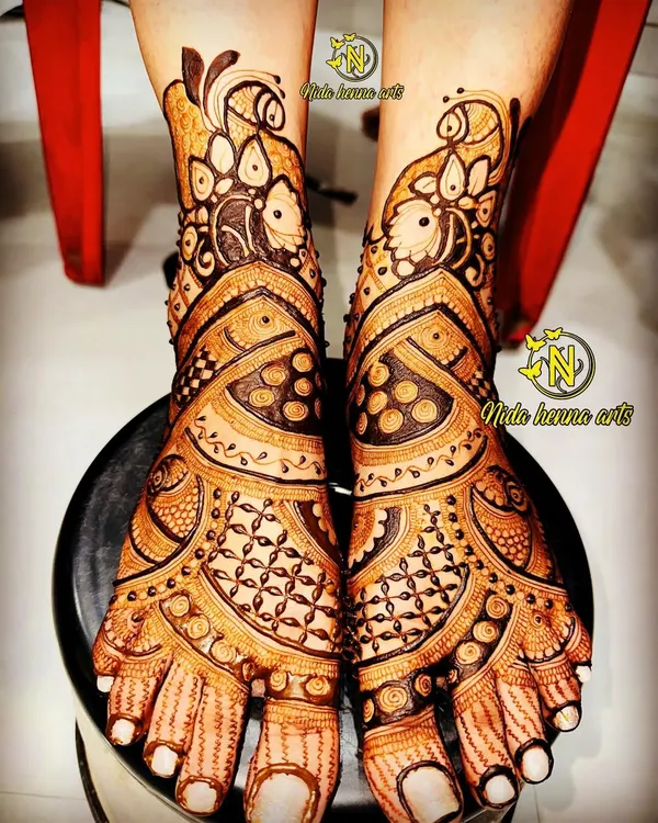This intricate bridal feet design was done by my talented students. It features peacock motifs and detailed patterns that cover the feet beautifully.