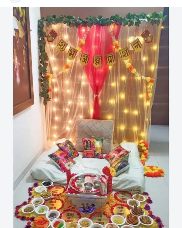 I create special, cozy setups for a baby's Annaprashan or first rice-eating ceremony. This design includes a soft, low seating area under a net canopy with twinkling lights, a 'Shubh Annaprashan' banner, and a traditional floral rangoli with spaces for all the ceremonial bowls.