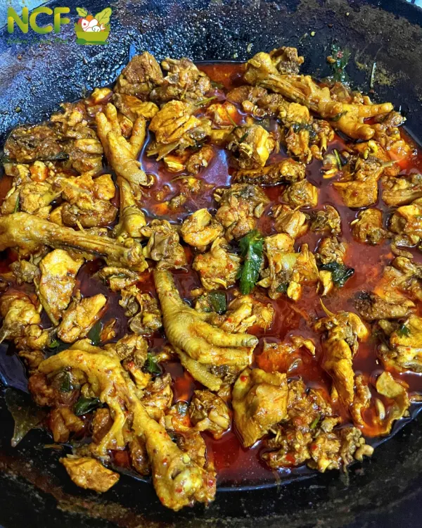 A luscious country chicken curry, cooked with bones and chicken feet for maximum flavor, just like at home.