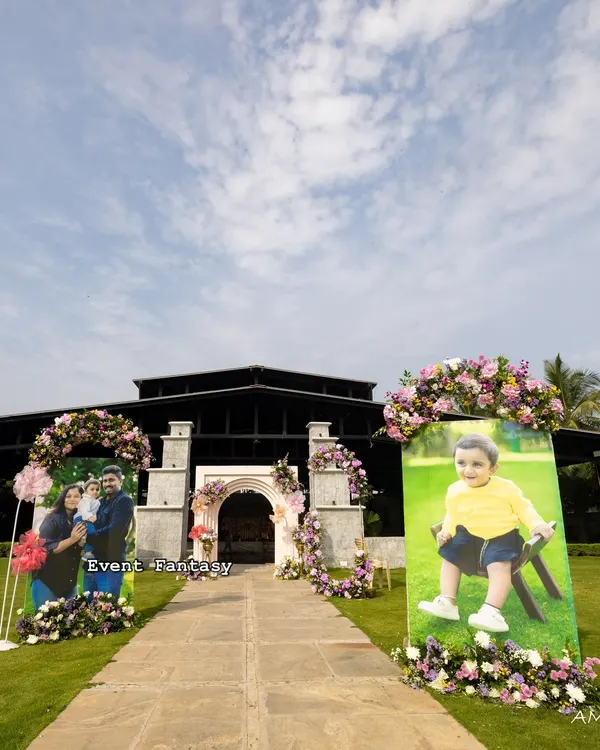 Creating a personal journey for guests as they arrive. For Dhanvith's naming ceremony, I lined the entrance path with large, beautiful portraits of the baby, each adorned with fresh flowers.