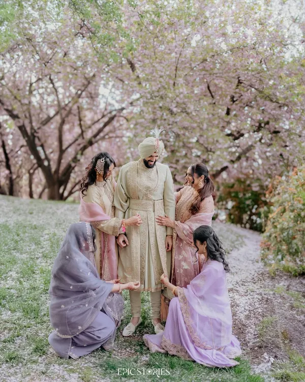Who says only brides get the Pinterest-worthy shots? We had a great time capturing the groom, Gurtaj, with his sisters under a shower of cherry blossoms. A beautiful and fun moment.