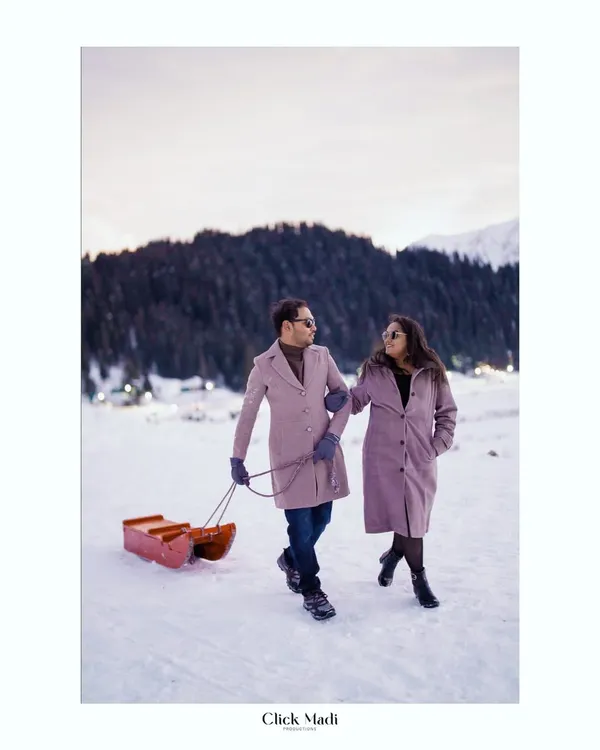 A romantic stroll through the snow in Kashmir. This pre-wedding shoot captures a quiet, cozy moment against a majestic winter landscape, showcasing the couple's connection.