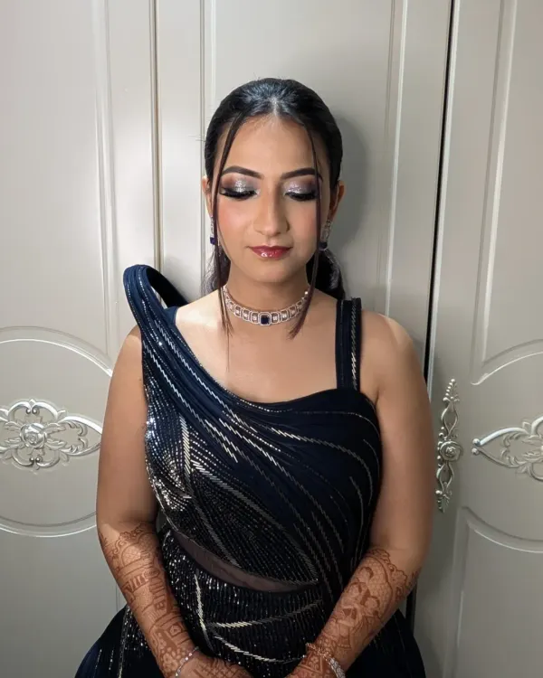 A modern and chic cocktail look featuring sharp, silver-toned smokey eyes and a sleek ponytail. This makeup is designed to be dramatic yet sophisticated, perfect for an evening of celebration.
