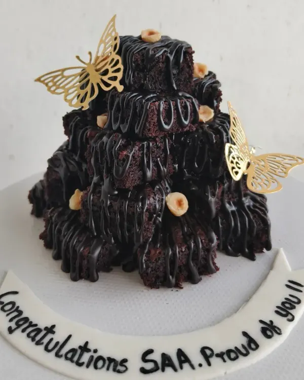 This is my signature Brownie Tower, a super fun and delicious alternative to a traditional celebration cake. It's made of stacks of my fudgy chocolate brownies, drizzled with more chocolate, and perfect for sharing.